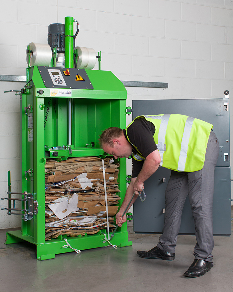 Man using cardobrd compactor